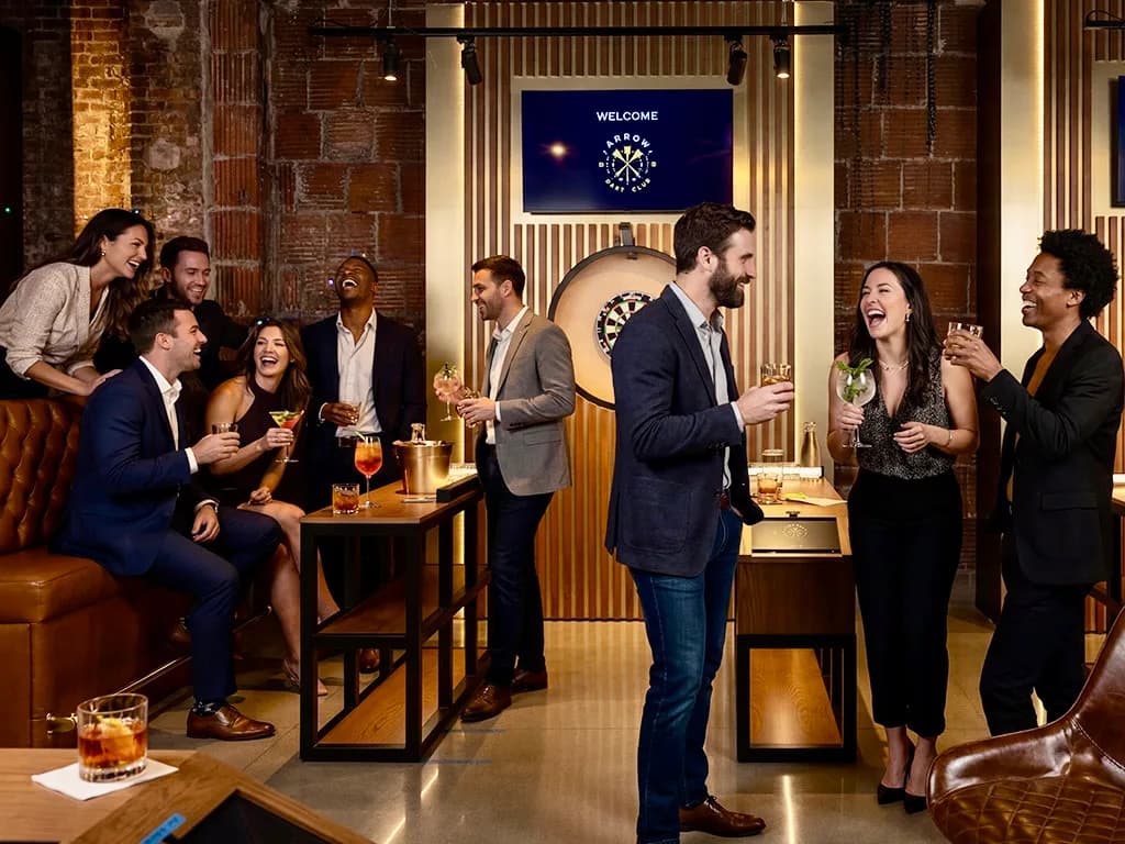 Group of friends laughing and socializing at Arrow Dart Club Kansas City