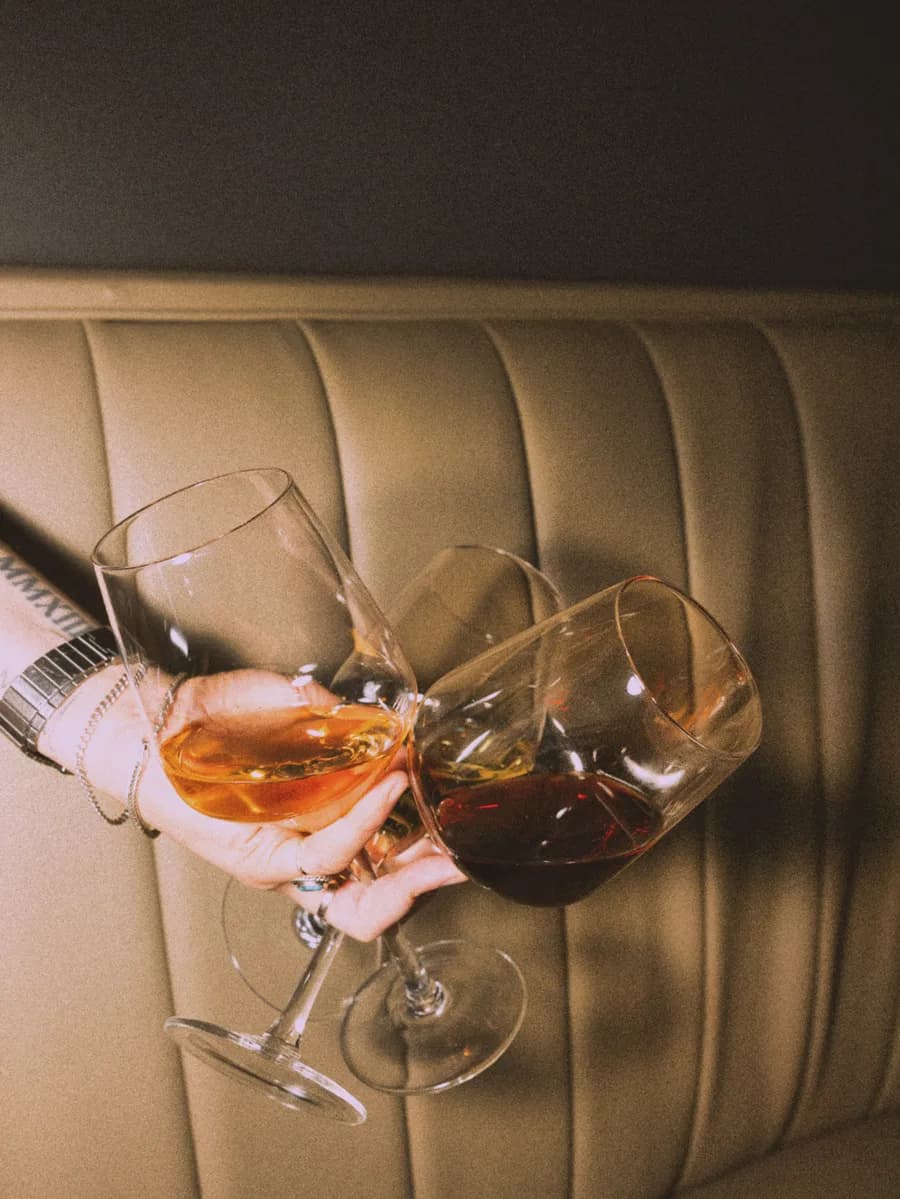 Wine glasses clinking at Sunken Cork hidden wine bar